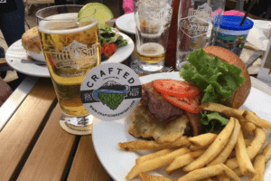 crafted podcast burger and fries with glass of beer