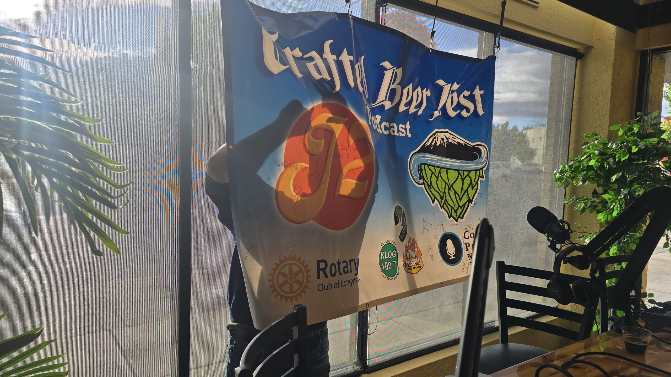 Erik Lassen, the owner of Almost Outdoors Signing the Crafted Beer Fest Podcast Banner